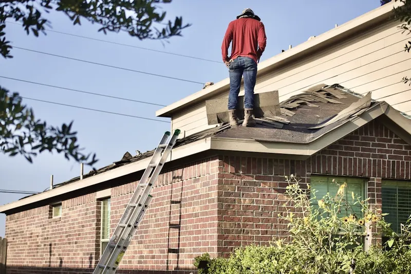 Professional roofer working on a residential roof in Riverplace